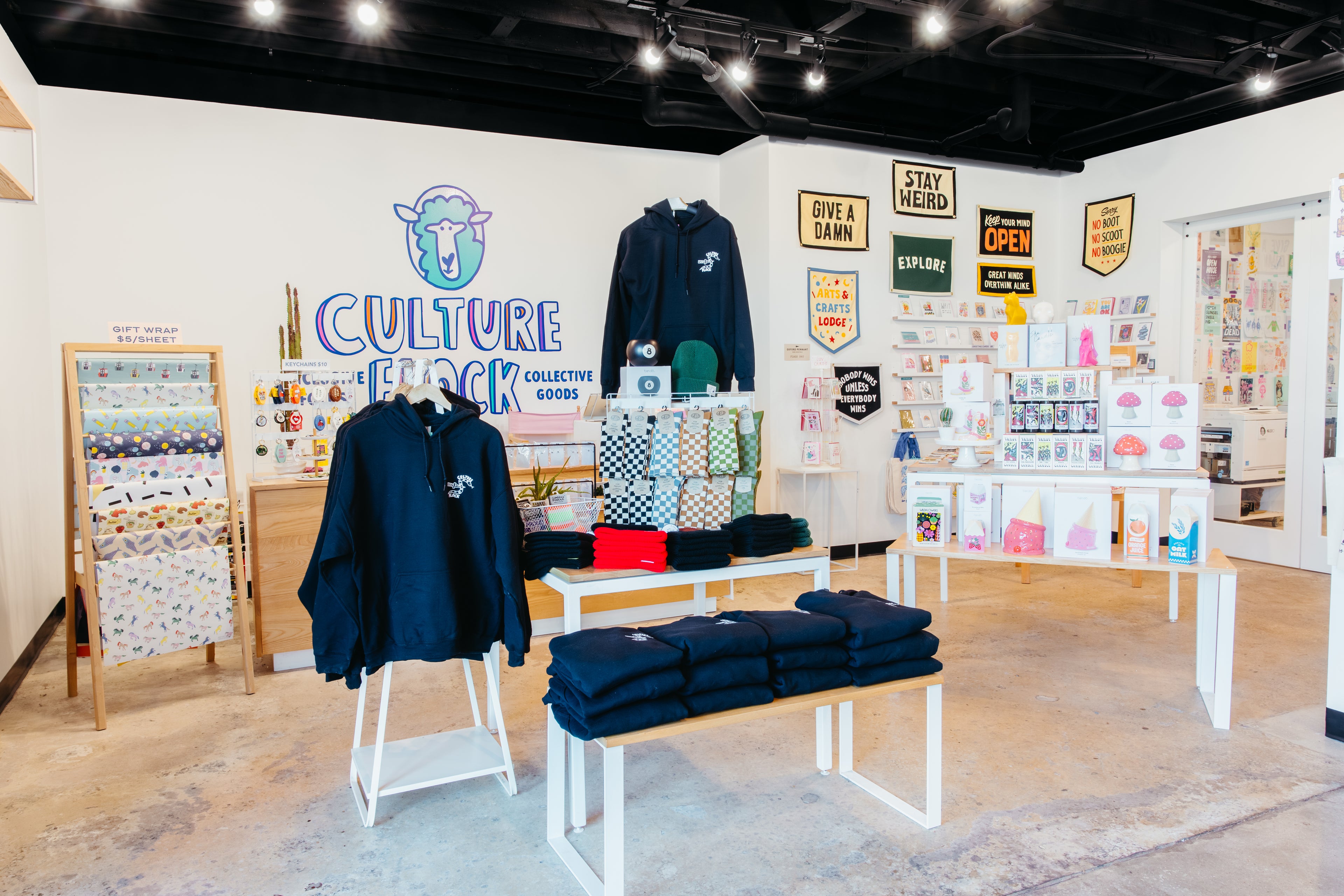 A look inside our shop featuring hoodies, socks, and home decor