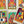 Load image into Gallery viewer, Illustrated tarot cards laid on a table. The cards depict illustrated scenes of grunge musicians.