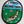 Load image into Gallery viewer, Oval patch that features a fish that is laying on green grass surrounded buy small flowers underneath a blue sky. In the sky, in black text, the patch says I don't belong here. White background.