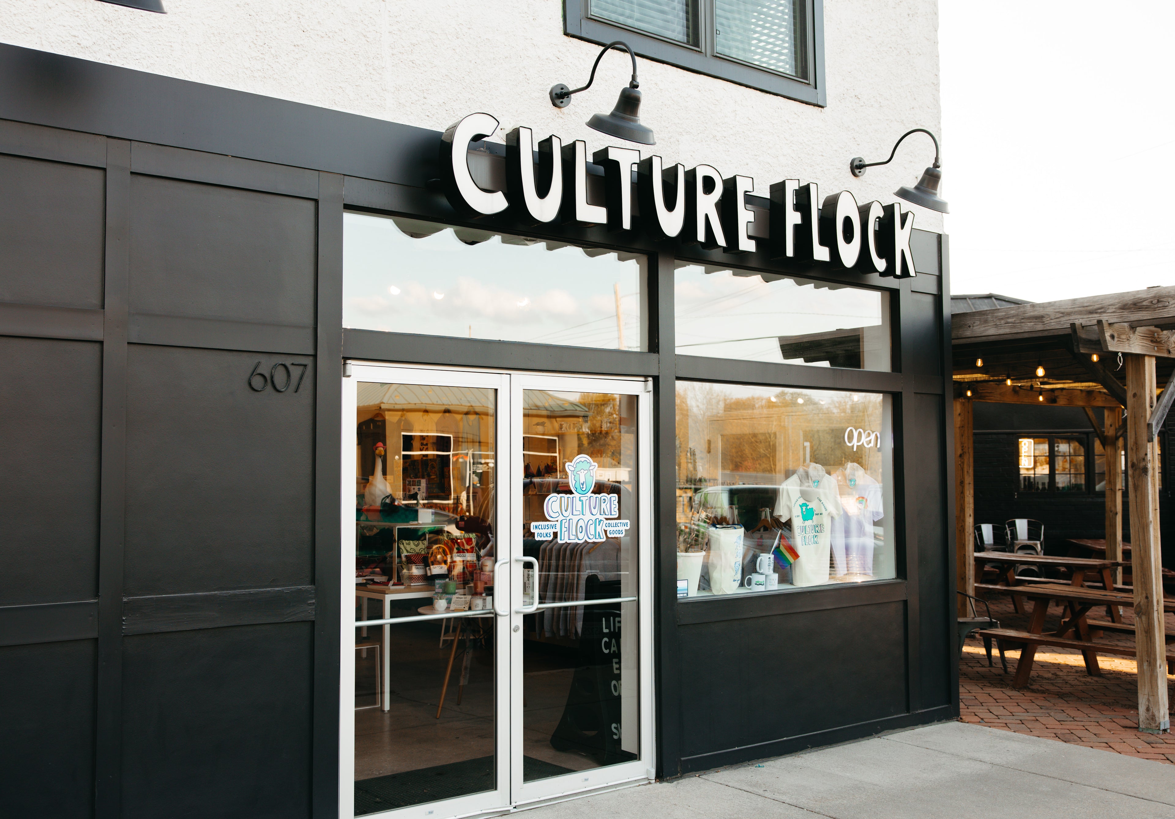 Storefront with 'Culture Flock' sign and glass doors
