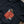 Load image into Gallery viewer, Black tshirt laying on a wooden table. The tshirt features an illustration of a red apple with gold stars and a green worm sticking out of it. The worm is frowning and below the apple in green text it says ROTTEN.