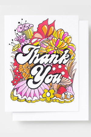 Greeting card that says Thank You in white and black cursive bubble lettering. Behind that are pink, orange, and yellow flowers.