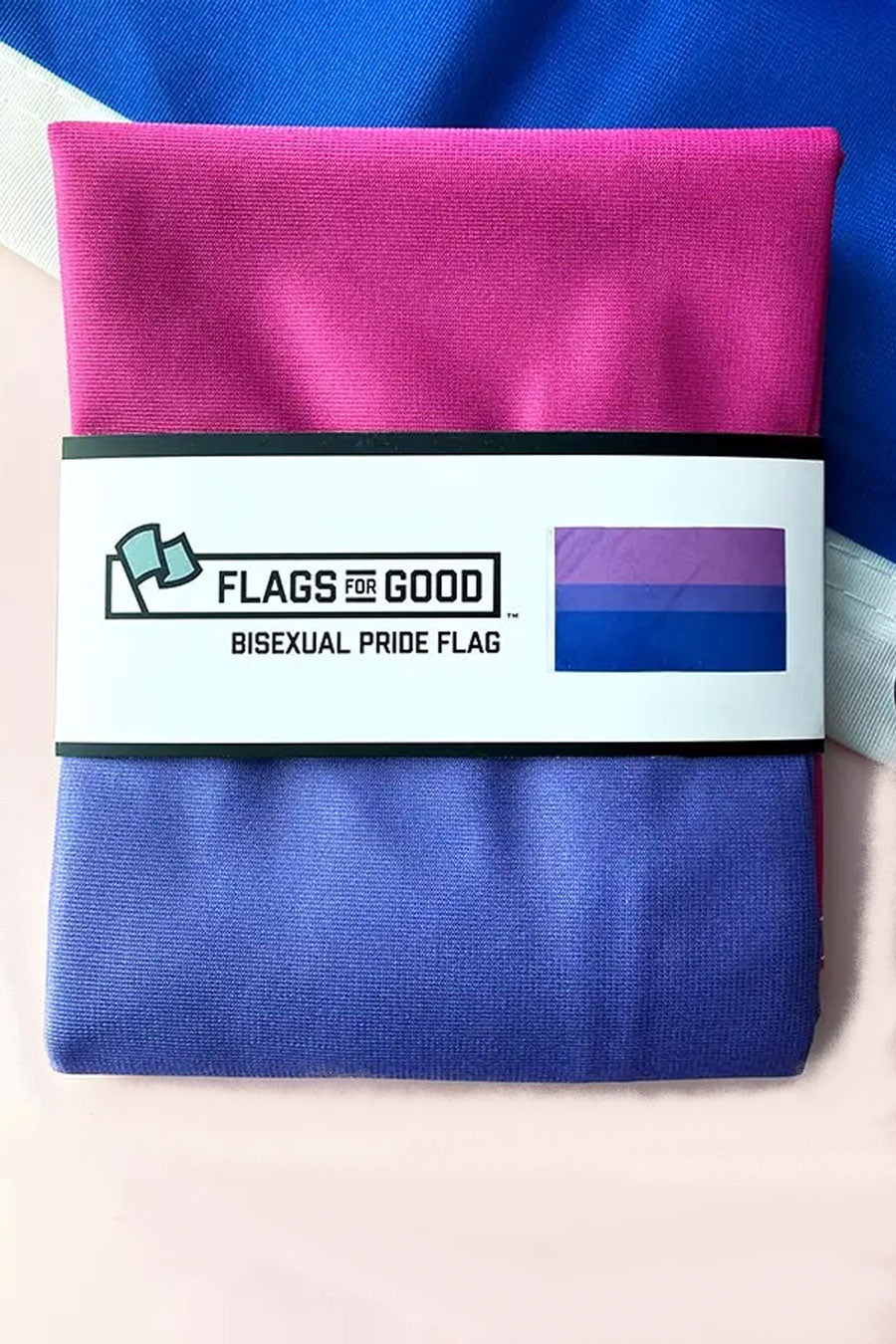 Folded Bisexual Pride Flag. The packaging around the flag says Flags for Good and depicts an image of the Bisexual Pride Flag. The flag consists of horizontal stripes of Pink, purple, and blue.
