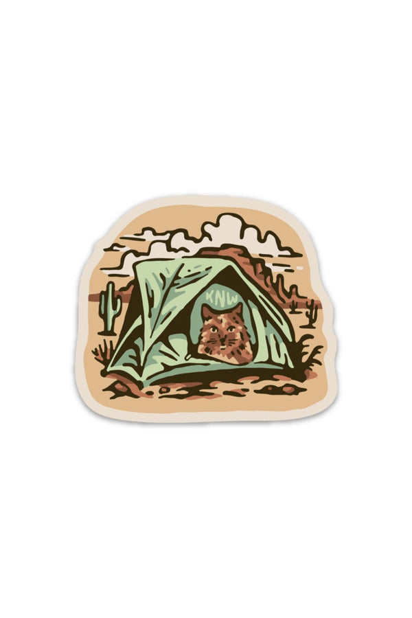 vinyl sticker of a cat in a green tent camping in the desert.