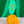 Load image into Gallery viewer, Green vintage motel style keychain. The keychain is sitting on top of a small piece of cheese in front of a green satin background. The keychain says Cheese Loves You Bakc in yellow lettering.