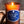Load image into Gallery viewer, Frosted amber glass candle jar with a raw edge cork top. Candle has a blue label that says Dark Rum and Oak. Natural wood and stone backdrop.