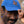Load image into Gallery viewer, Photograph of a man outside wearing a blue baseball cap, with his hand on the brim of the hat. The hat features a red winged blackbird in flight.