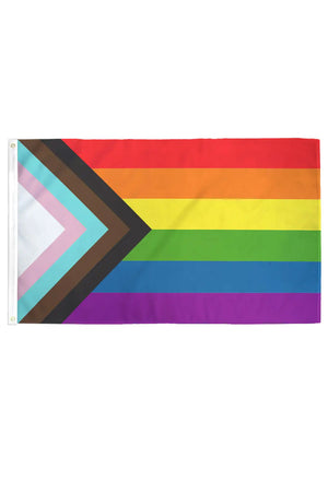 Progress Pride Flag laid out on a white backgroun. The Progress Pride Flag includes a black, brown, blue, pink and white stripe layered on top of the rainbow colors.
