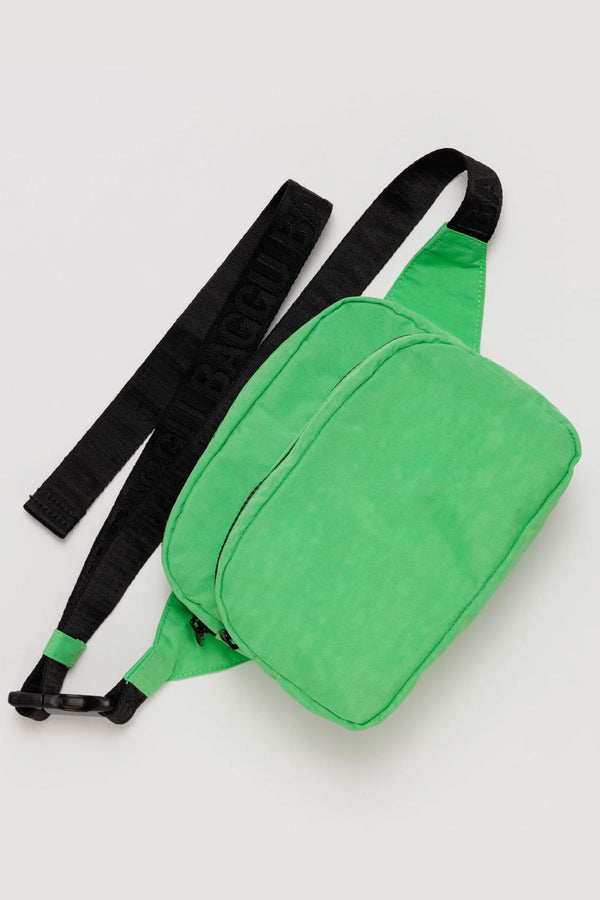 Nylon fanny pack with black straps and two compartments. Fanny pack is Aloe Green.