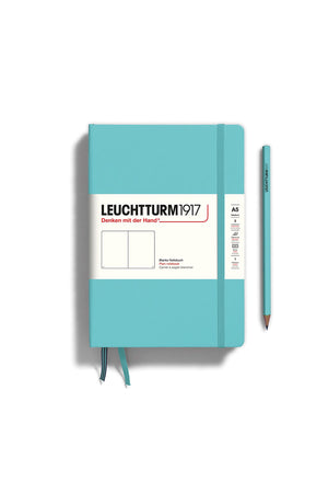 A5 sized hardcover sketchbook in Aquamarine. Two ribbon page markers and elastic strap to keep the book secured. White background. Pencil not included.