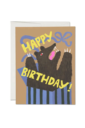 Greeting card of a bear springing out of a box. Card says Happy Birthday!