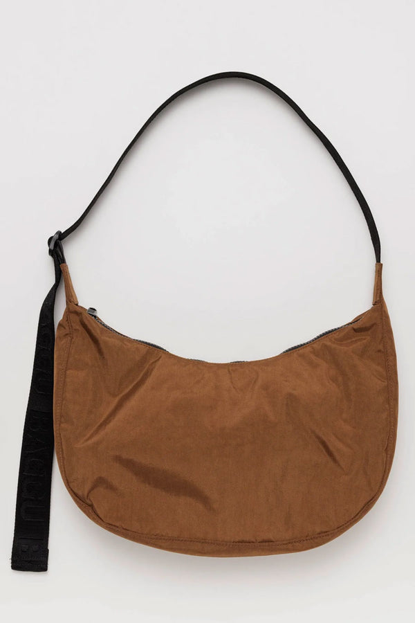 Crescent shape nylon bag with black adjustable strap. White background.