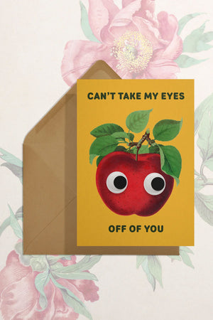 Yellow Greeting card with kraft brown envelope. The card features a red apple with googly eyes and says Cant take my eyes off of you. 