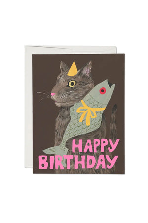 Birthday of a Cat holding a fish. Card says Happy Birthday in pink text.