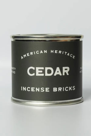 Tin container with a green label that says American Heritage Incense Bricks. The scent is Cedar. White background.