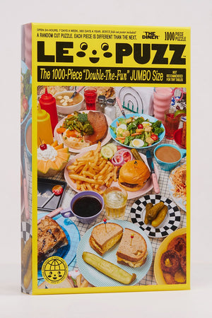 1000 piece puzzle called The Diner. The puzzle features a diner tabletop filled with diner food and drinks.