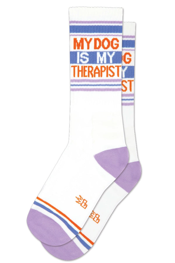 Mid calf athletic socks with a purple heel and toe. and Blue, purple and green stripes across the tops. Blue and red stripes across the toes. The socks say My Dog is my Therapist in red lettering. White background.