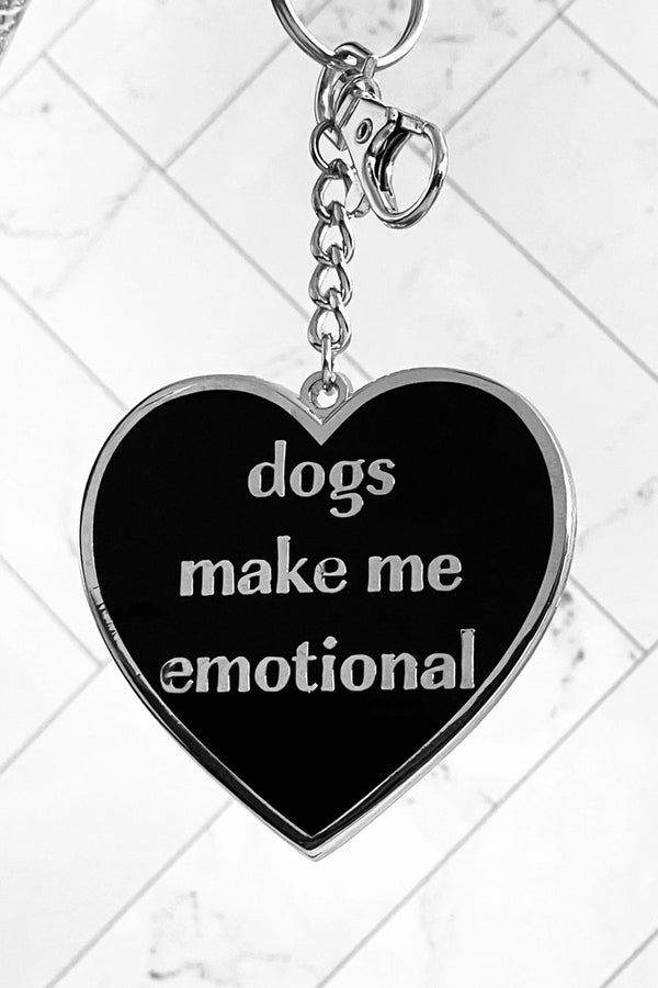Black enamel heart keychain with silver hardware. The heart says Dogs make me emotional in silver text.