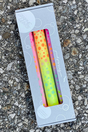 Set of three taper candles hand dipped in rainbow gradient colors and with hand printed dots all over.