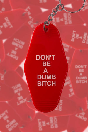 Red vintage style keychain that says Don't Be A Dumb Bitch in white text.