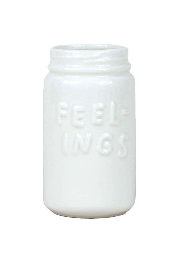 White Ceramic vase shaped like a mason jar. The jar says Feelings on the front. White background.