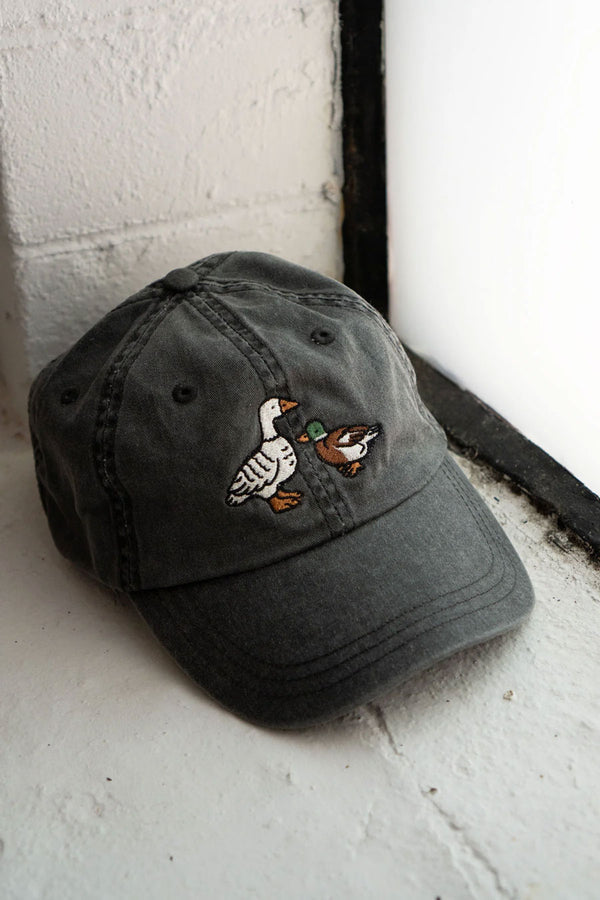 Faded black denim dad hat with two embroidered ducks.
