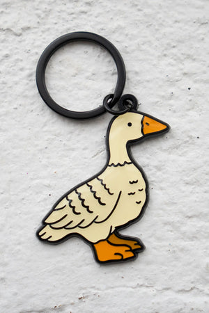 Enamel keychain with black hardware of a white duck.