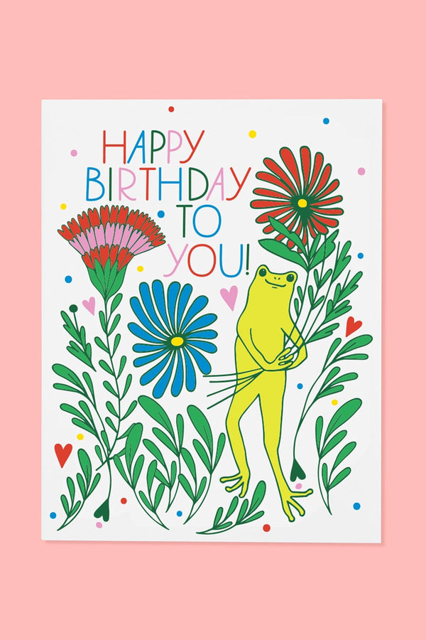 Greeting card of a Frog holding flowers and surrounded by other multicolor flowers, dots, and heart. Above that the card says Happy Birthday To You!