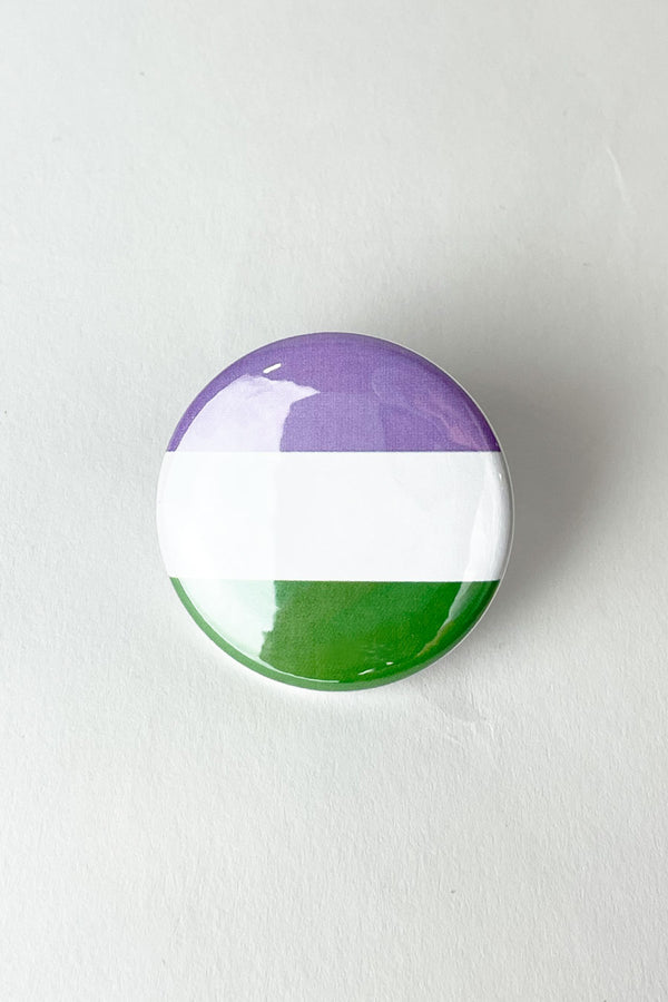 A pinback button featuring the colors of the genderqueer pride flag.