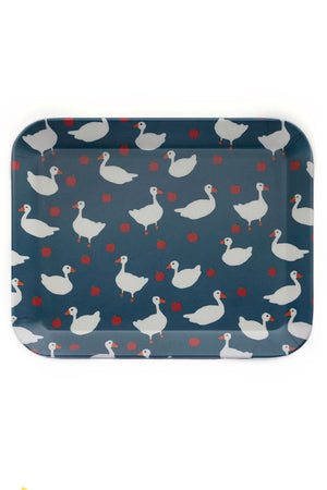 Navy blue tray with an all over print of white geese and apples. White background.