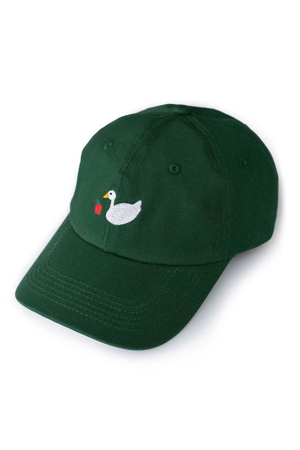 Green dad hat featuring embroidered design of a white goose and a red apple. White background.
