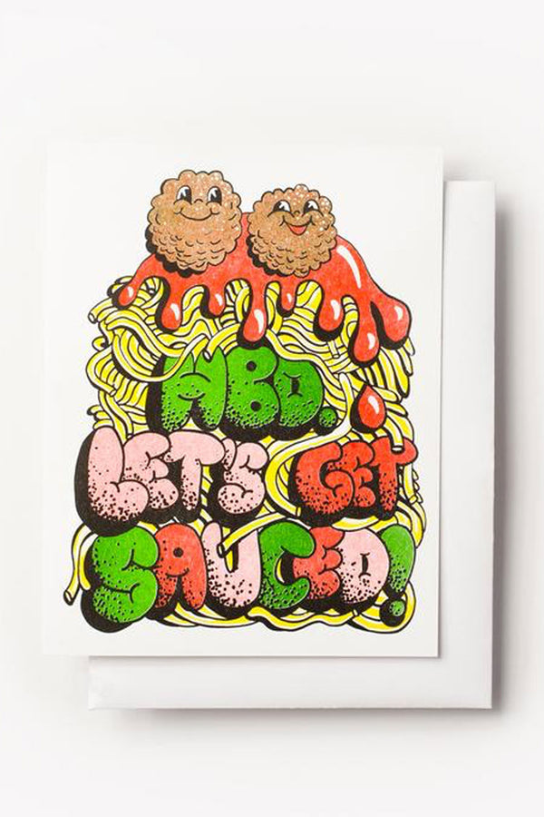 A pile of spaghetti noodles with red sauce and two meatballs with smiley faces on top. The card says HBD Let's Get Sauced in bubble letters.