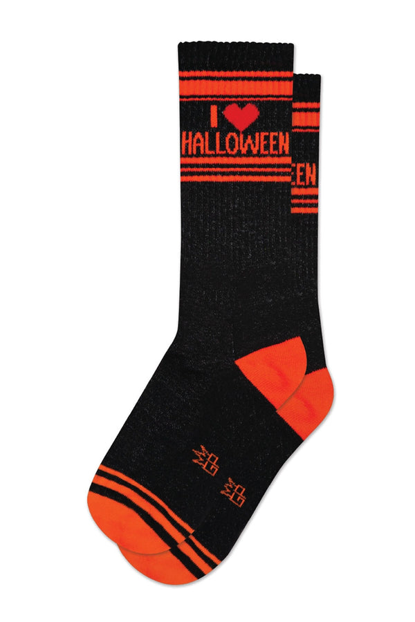 One pair of black mid calf athletic socks with an orange heel and toe and orange stripes running across the top and across the toes. The socks say I Heart Halloween in orange text. White background.