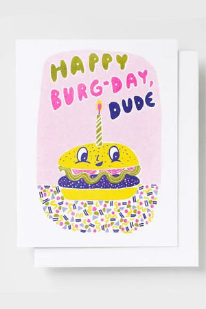 Greeting card featuring a hamburger with a smiley face and a lit birthday candle on top. The card says Happy Burg-Day Dude. White background.