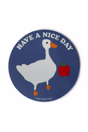 Blue Circle sticker featuring a goose and an apple. Sticker says Have a Nice Day above the goose in white text. 