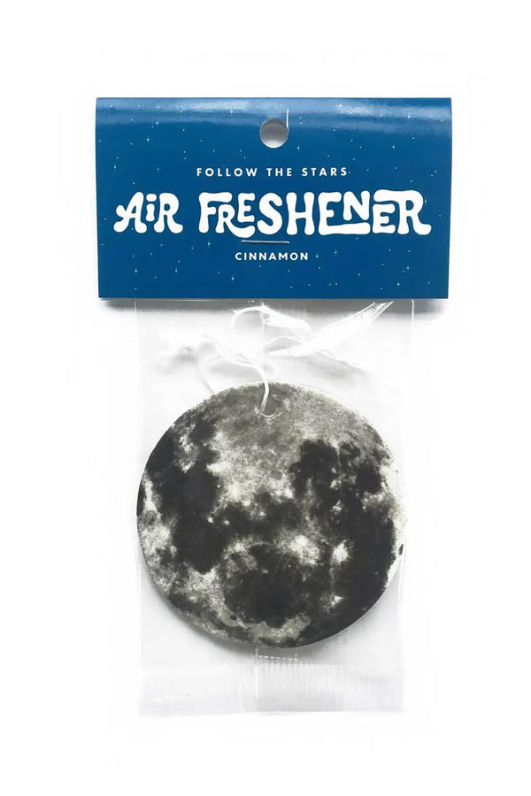 Air freshener in the shape of the moon. Scent is cinnamon. White background.