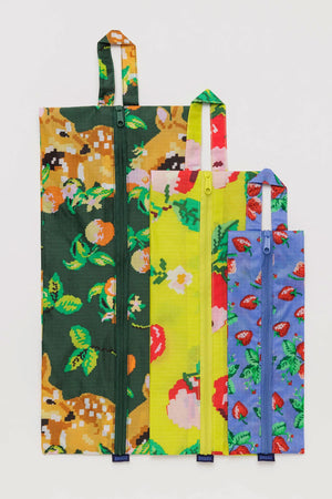 nylon storage bags in three different needle point designs. The designs feature a deer with fruit, yellow with red apples, and blue with strawberries.