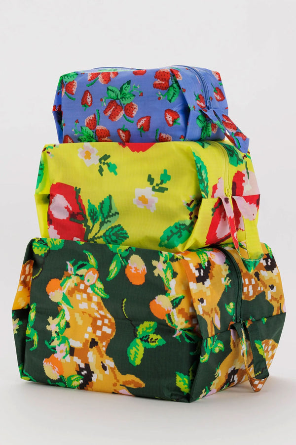 nylon storage bags in three different needle point designs. The designs feature a deer with fruit, yellow with red apples, and blue with strawberries.