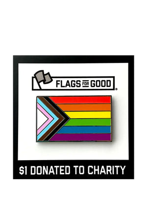 Enamel pin affixed to a black and white backing board. The Pin is of the Progress Pride Flag. The flag includes a black, brown, blue, pink and white stripe layered on top of the rainbow colors. White background.