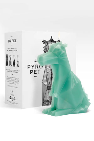 Geometric Dragon shaped candle in green. The candle is sitting in front of the box that it comes with. The box says Pyro Pet and has an illustration of the skeletal frame that is revealed when the candle melts. White background.