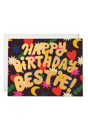 Greeting card that says Happy Birthday Bestie! Card is maroon with colorful hearts, stars, and moons.
