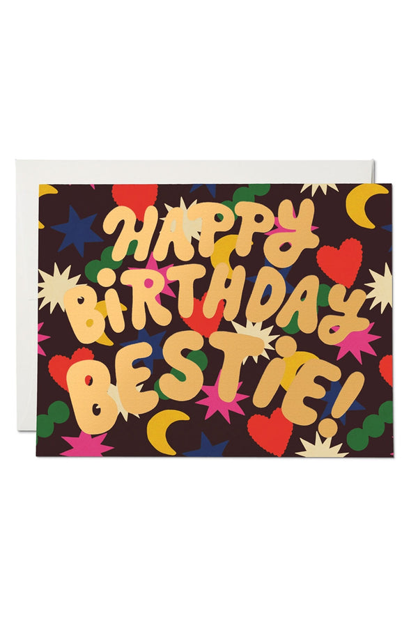 Greeting card that says Happy Birthday Bestie! Card is maroon with colorful hearts, stars, and moons.