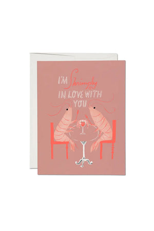 Greeting card of two Shrimp dining at a table with Shrimp cocktail. Card says I'm Shrimply In Love with You