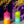 Load image into Gallery viewer, Hand dyed pillar candles. One candle is pink, orange and white. The other is lime green, white, and teal.
