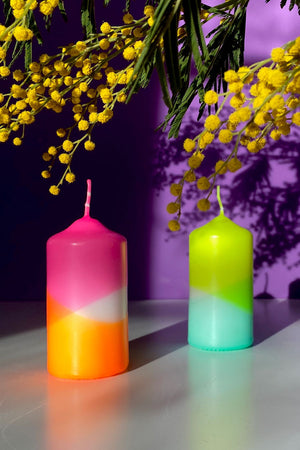 Hand dyed pillar candles. One candle is pink, orange and white. The other is lime green, white, and teal.
