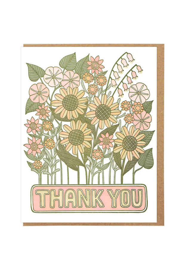 White greeting card featuring illustration of sunflowers, poppies, and other assorted flowers. Underneath the flowers the card says Thank you in yellow bubble letters. Kraft brown envelope. White background
