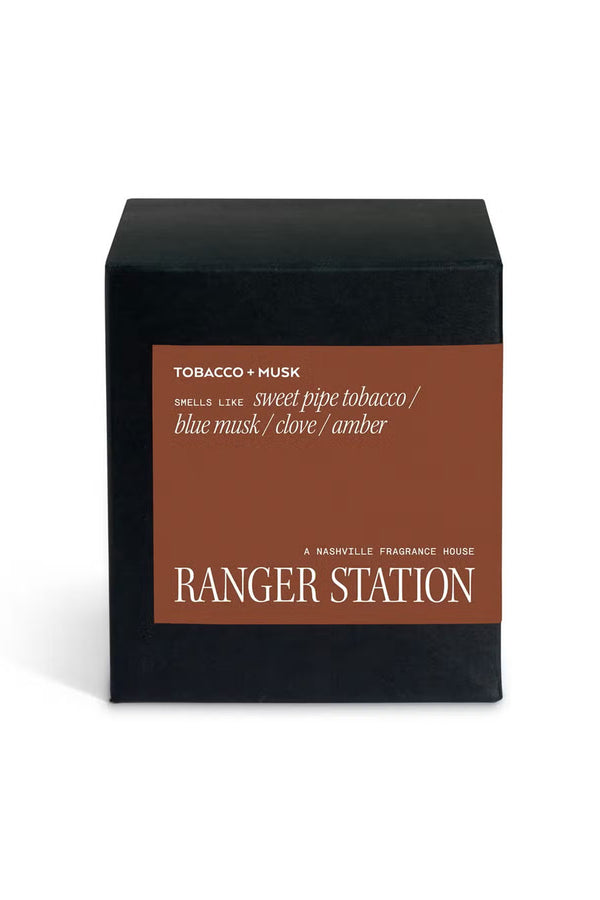 Black candle box with brown label that says Ranger Station A Nashville Fragrance House. The scent is Tobacco and Musk