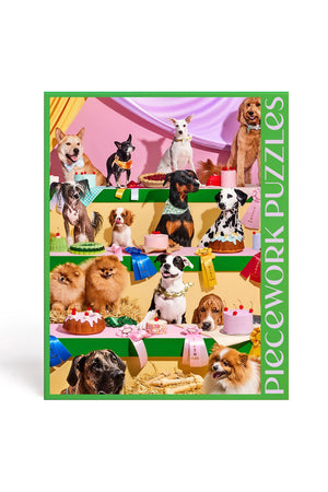 1000 piece puzzle of 14 dogs sitting in front of cakes and prize ribbons.