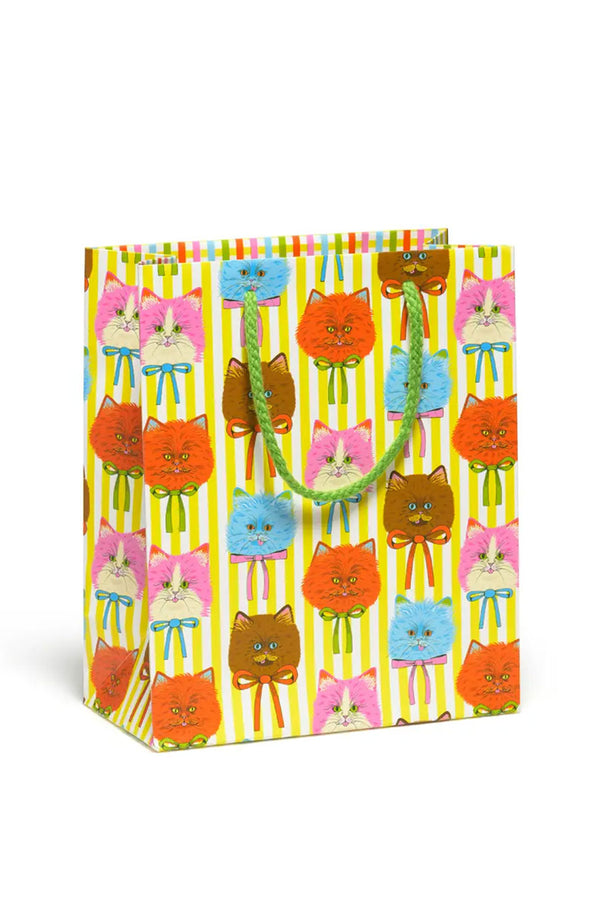 Yellow and white gift. bag with green rope handle. Printed all over the bag are blue, orange, brown, and pink and white cat heads.