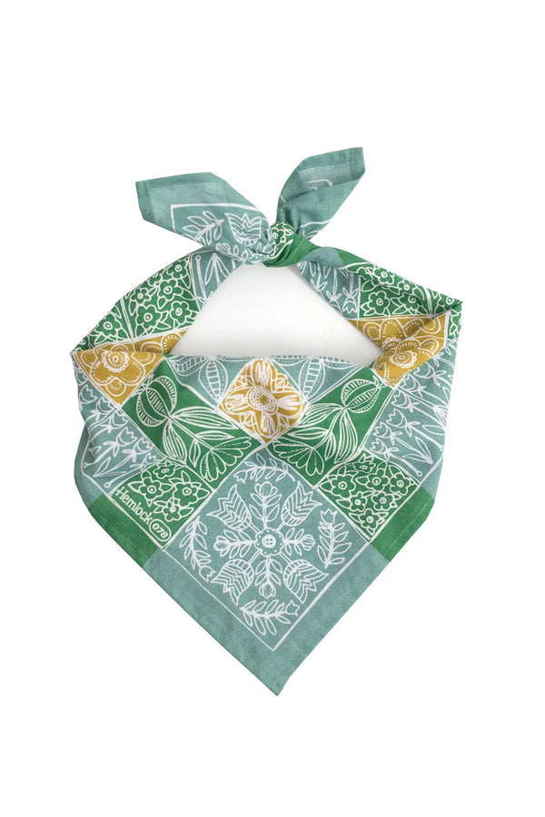 Knotted Green and blue quilt pattern bandana with white flowers. White background.